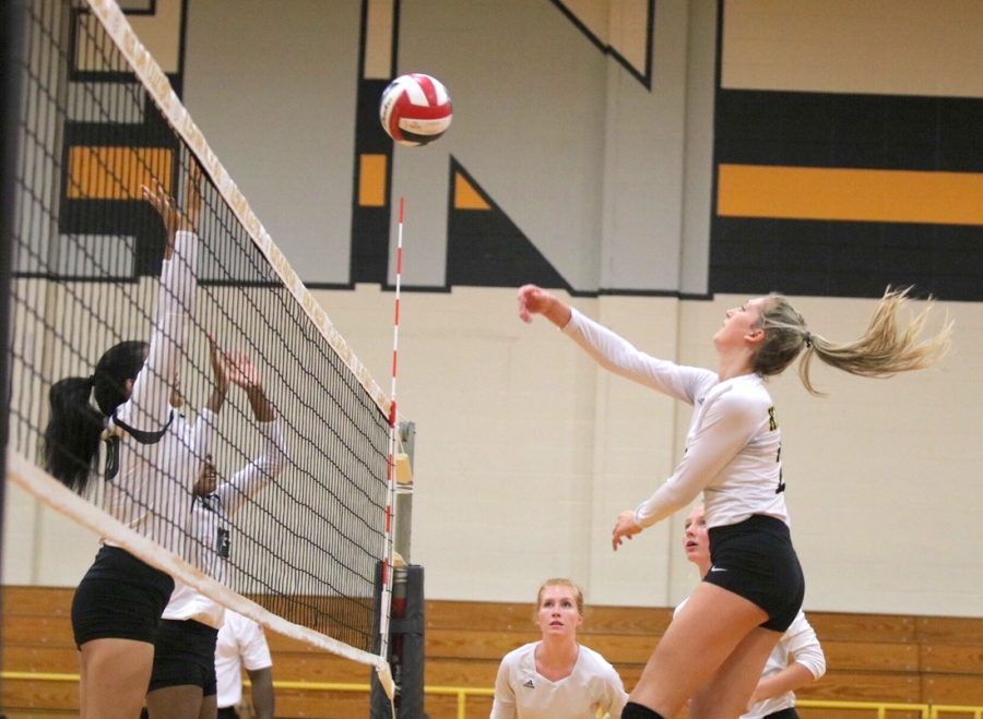 Senior Sydney Moxcey spikes the ball over the net in Klein Oaks victory over Cy Falls, Tuesday, August 7, 2018
