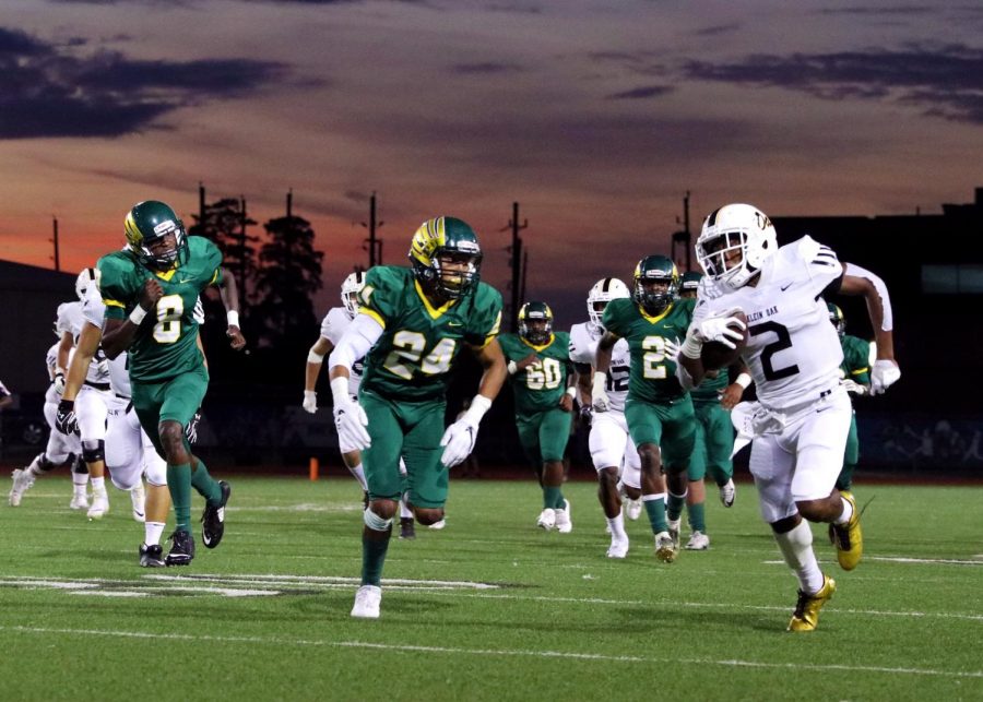 Junior running back Kendal Taylor sprints past the Klein Forest defense for a first down.