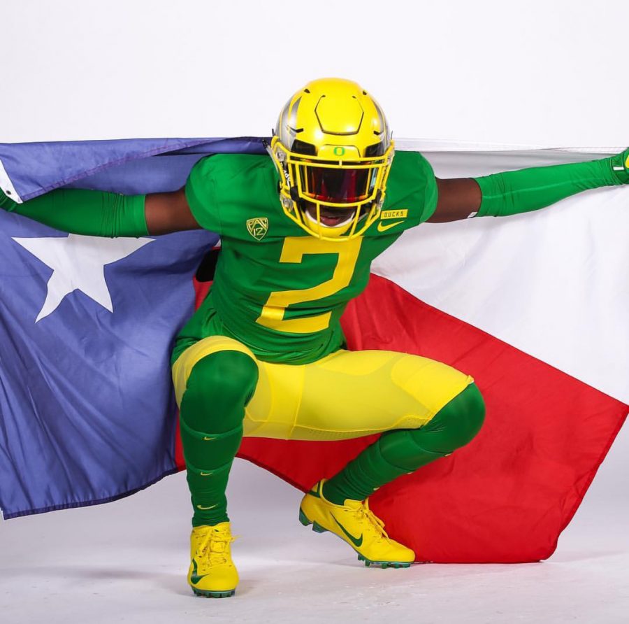 While on an unofficial visit to the University of Oregon, junior Dwight McGlothern poses in the green and yellow  threads. Head Coaches around the nation utilize this tactic to lure in potential recruits across the country.