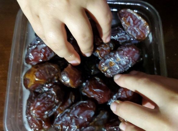At sunset, the Islamic recommended form of breaking a fast is eating
Arabic dates. 