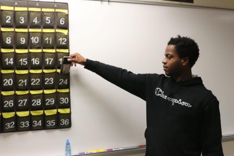 Senor David Oderinde  puts his phone in phone jail for the  duration of Brad Rices math class. The cell phone policy at Klein Oak differs from teachers to teacher, but the thought about cell phone are the same: when they become a distraction, they are to be put away.  