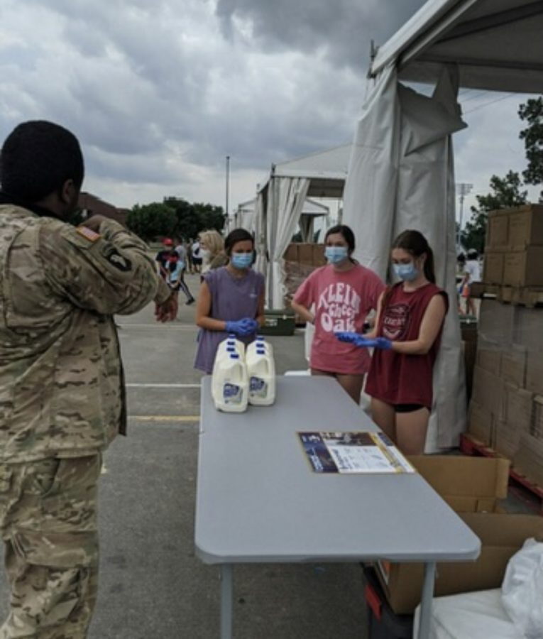 Seniors Aubrey Desantis (left), Emma Osborne (center), and Clare Bearden (right) volunteering for NHS. They worked food distribution tables for  the Houston Food Bank and wore masks as a coronavirus precaution.