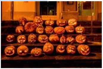 Carved pumpkins sit out on the porch anticipating trick or treaters to be spooked while they gather all the sweets they can carry.