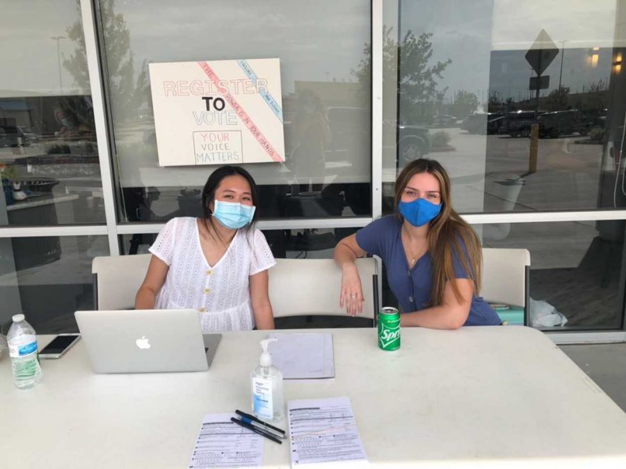 Sitting at the registration booths, seniors Lucia MoraUrbina and Caitlyn Nguyen anticipate eligible voters to pick up available registration forms outside the Nails of America Salon. 