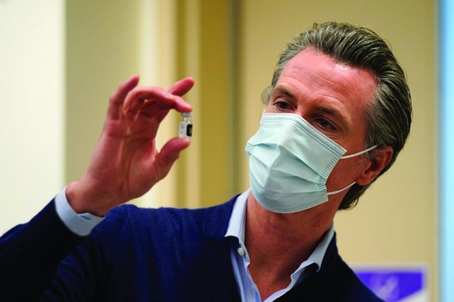 California Governor Gavin Newsom takes a first look at the newly approved COVID-19 vaccine developed by Pfizer. 
