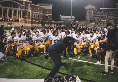 Coach Glenn and company celebrate their round one playoff win against Cypress Ranch Mustangs, 30-6.