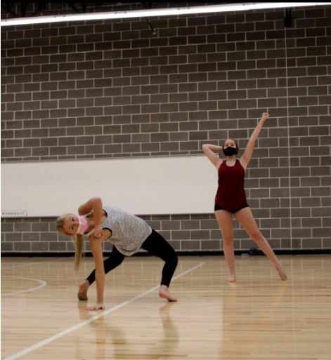 Junior lieutenant Landry Albright and rookie Kylie Stuart are practicing their pom contest routine in the new Strutter studio. The wood flooring allows the dancers to perform to their full potential during practice. The lines also help the dancers stay in formation throughout routines.