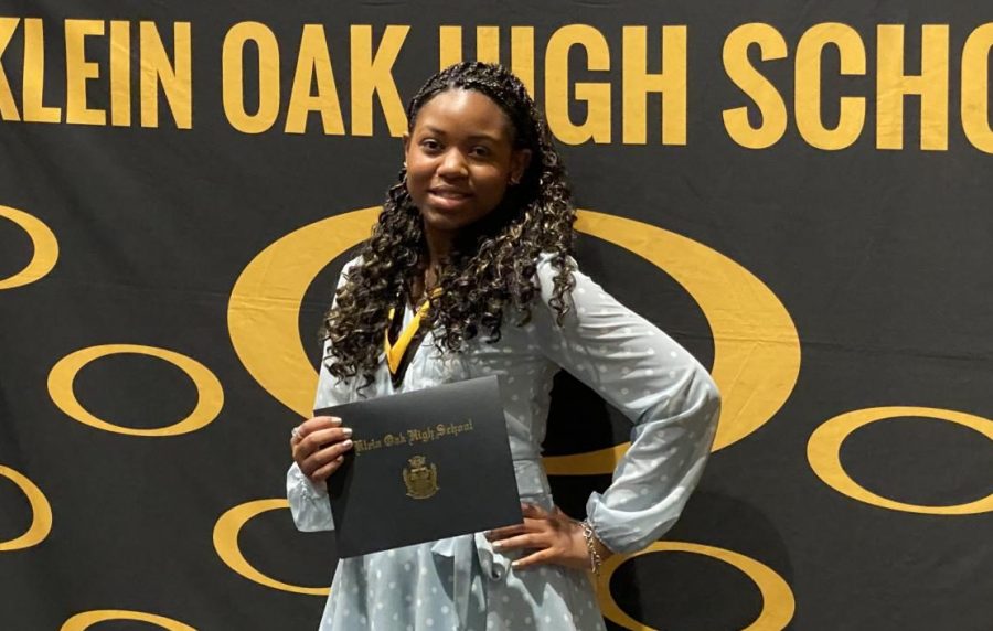 Graduating 20th in the Class of 2021, sophomore/senior PJ Miller poses with her honors at the Klein Oak Top 10% Ceremony.