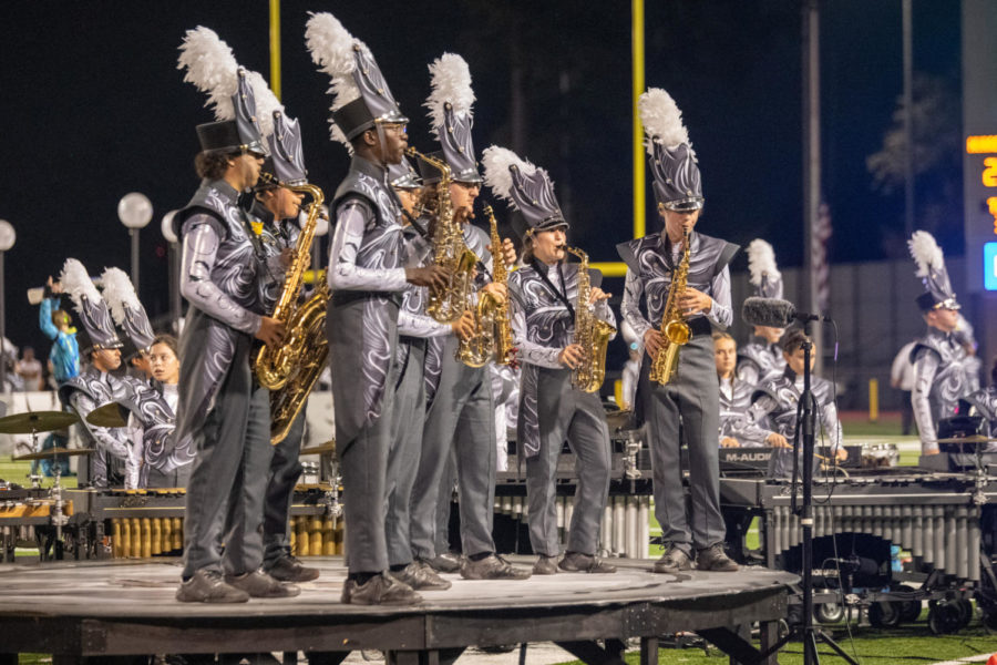 The production highlights different sections of the band to showcase specific talents. One such group ensemble includes the saxophones.