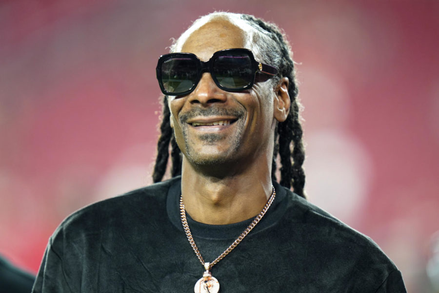 Entertainer Snoop Dogg walks on the field before an NFL football game between the Tampa Bay Buccaneers and the New Orleans Saints Sunday, Dec. 19, 2021, in Tampa, Fla. Snoop Dogg says he won’t let the big Super Bowl stage rattle his nerves. The ultra-smooth rapper said he will worry about his upcoming halftime performance after the fact. He’ll take the stage with Dr. Dre, Eminem, Kendrick Lamar and Mary J. Blige during Super Bowl 56 on Sunday, Feb. 13, 2022. 