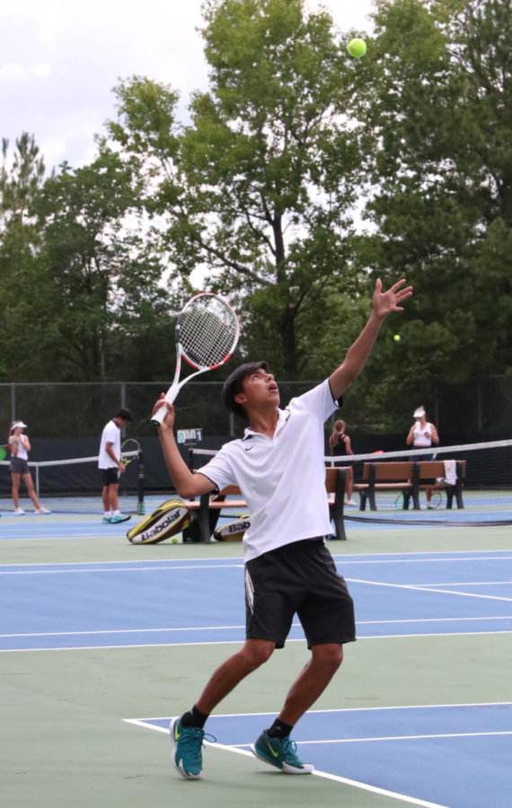 Sophomore Daniel Duque serves the ball to the opponent in hopes of gaining an advantage in the match.