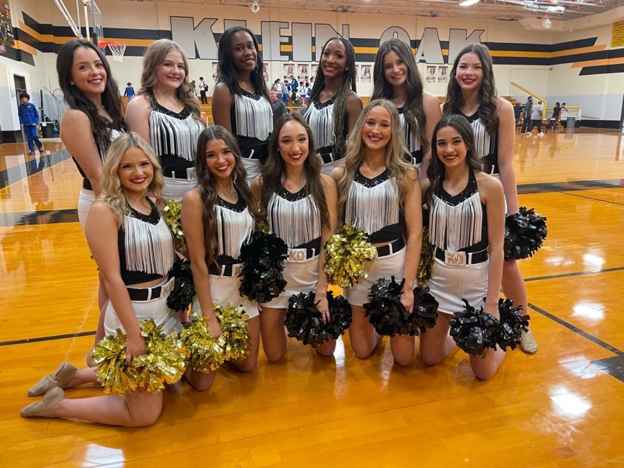 Showing off their new Strutter uniforms, the basketball squad pose for a photo after the win for the Panthers.