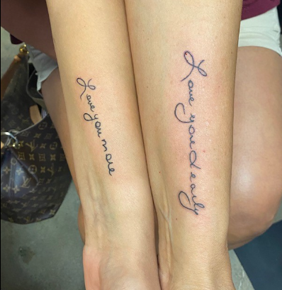 Fashion Marketing and Advertising teacher Brenda Sims shares two meaningful tattoos with her daughter.  [The picture] shows the tattoo my daughter and I got together when my mother passed away. My mother had very distinctive and pretty handwriting, so we pulled out cards she had given us over the years and discovered that on my cards, she always signed them ‘Love you dearly,’ and my daughters were always signed ‘Love you more,’ so that is exactly what we had tattooed on our forearms in her handwriting. Every time we see it we remember how much we love her and how much she loved us.”
