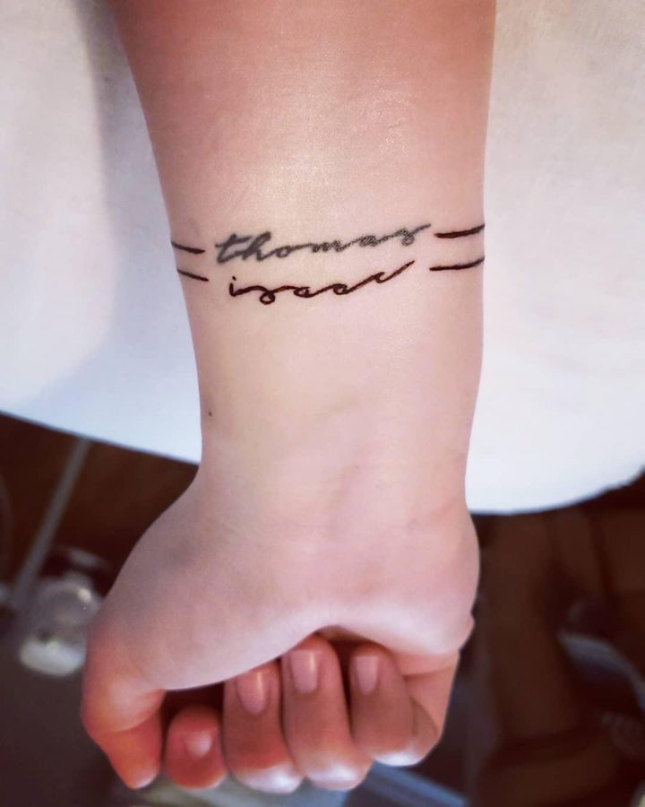 This tattoo is on my right forearm. It has both of my sons names in a handwritten script and one solid line around my arm for each, making a bracelet effect. Their names are Thomas and Isaac, but we call them Tommy and Ziggy. We chose both of their names with a lot of significance and personal meaning behind them.
-Alana Clark, AP Statistics teacher. 