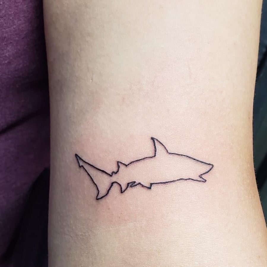 I have a shark outline tattoo on my left arm right above my elbow crease. My best friend was in town, and we hadnt seen each other for a few years at that point. We wanted to commemorate the visit with matching tattoos, and after going back and forth quite a bit, we finally agreed on shark outlines! We have different sharks in the same style.
-Alana Clark, AP Statistics Teacher.