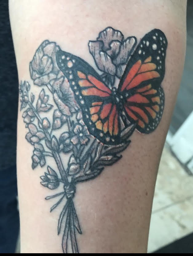 A monarch butterfly on a bouquet of wildflowers. My mom was all about plants and nature. Her favorite thing to do on road trips was to point out all the different wildflowers we would pass on the road. When she read about the monarch butterfly population decreasing, she made it her lifes mission to save them. She had my dad screen in half of our porch and she created her own butterfly garden where she bred, raised, and released monarchs. After she passed suddenly in 2018, I wanted something that represented what she loved about the world and what I loved about her.
-Michaela Eisman, staff.