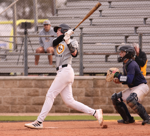 Swinging for the ball, junior Reed Osborne bats against College Park.