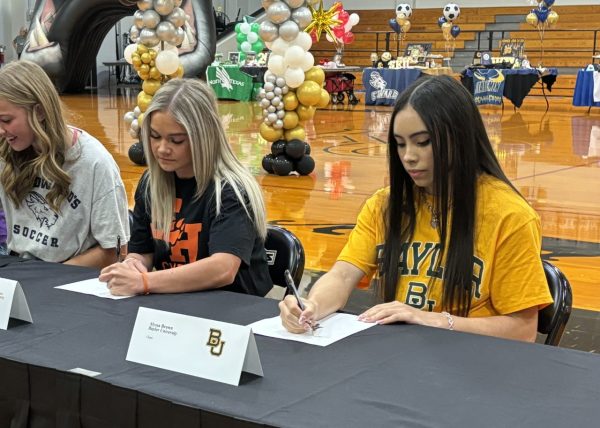 Some students choose to attend universities that will allow them to stay involved in their sport. Seniors Kennedy Rinehart (Sam Houston State) and Alyssa Brown (Baylor University) sign letters of intent to cheer and tumble in college.