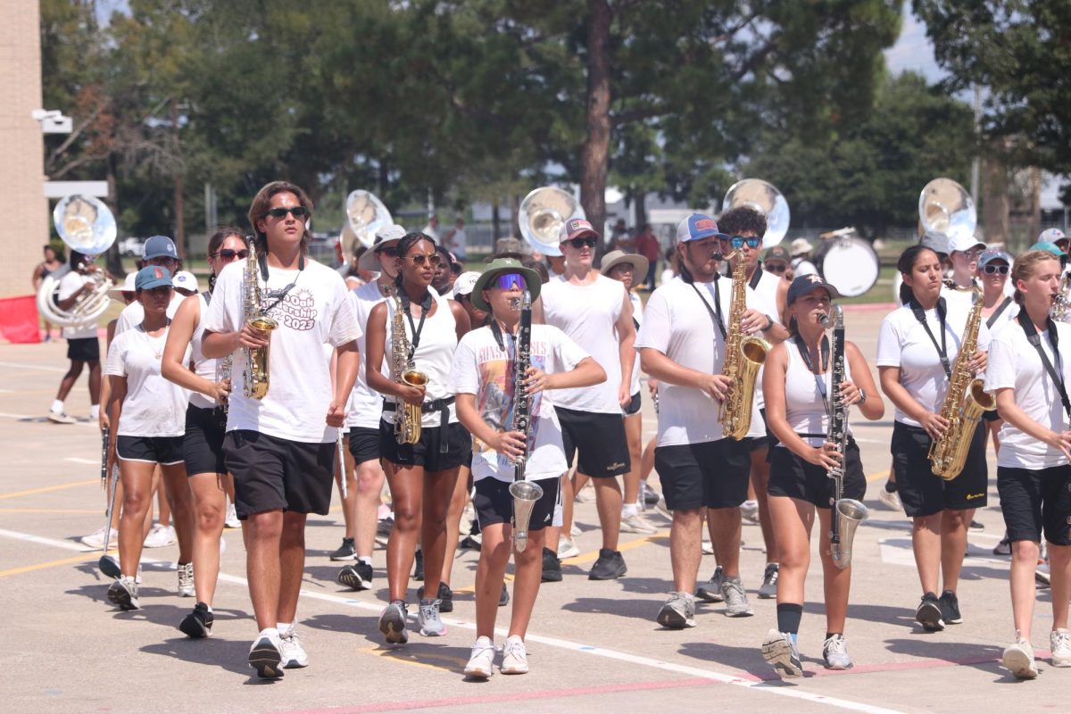 Keeping perfect time despite afternoon heat, Joshua Nonhof, Daxx Jackson, Nataleigh Williams, and Kirby Everett perform during the Band Parent Performance.