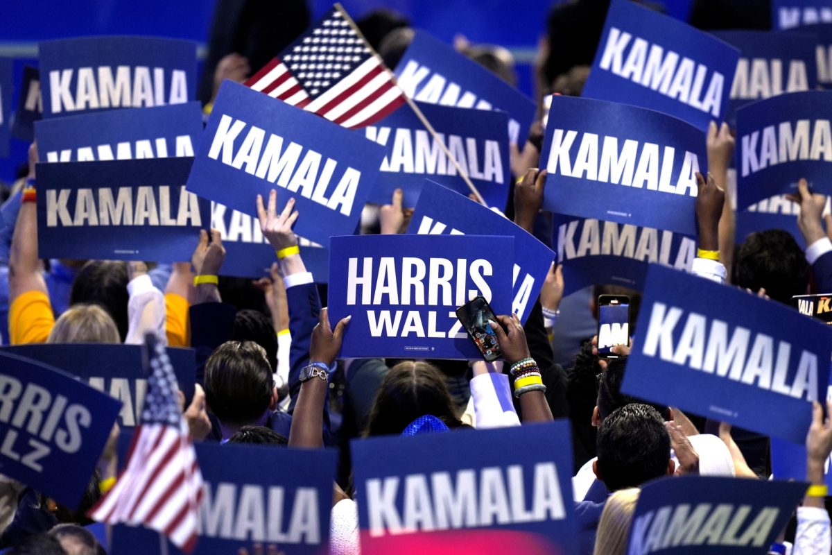 Supporters carry signs as Democratic presidential nominee Vice President Kamala Harris speaks during the Democratic National Convention Thursday, Aug. 22, 2024, in Chicago. 