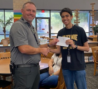 After missing only one question on the PSAT, Sid Sinnabhadti receives a certificate from Prinicpal Thomas Hensley, recognizing him as a Semi-Finalist for the PSAT scholarships.