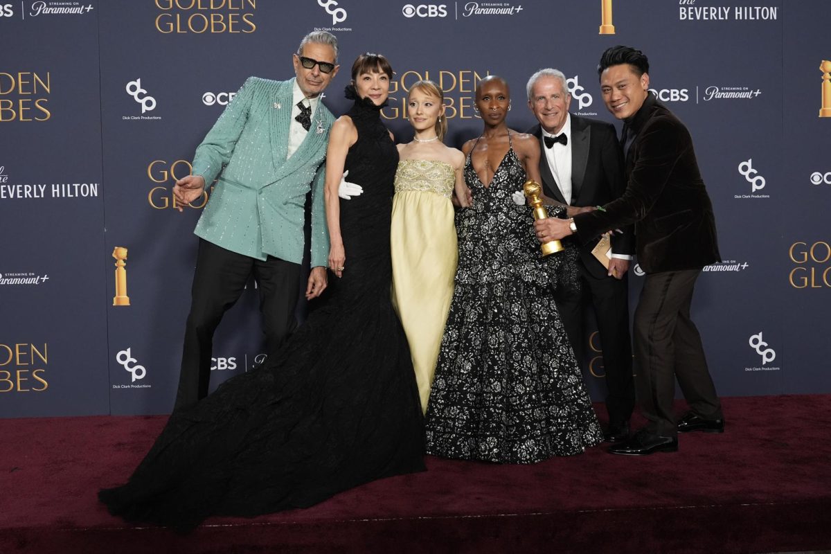  Jeff Goldblum, Michelle Yeoh, Ariana Grande, Cynthia Erivo, Marc Platt, and Jon M. Chu pose with the award for cinematic and box office achievement for "Wicked" in the press room during the 82nd Golden Globes on Sunday, Jan. 5, 2025.