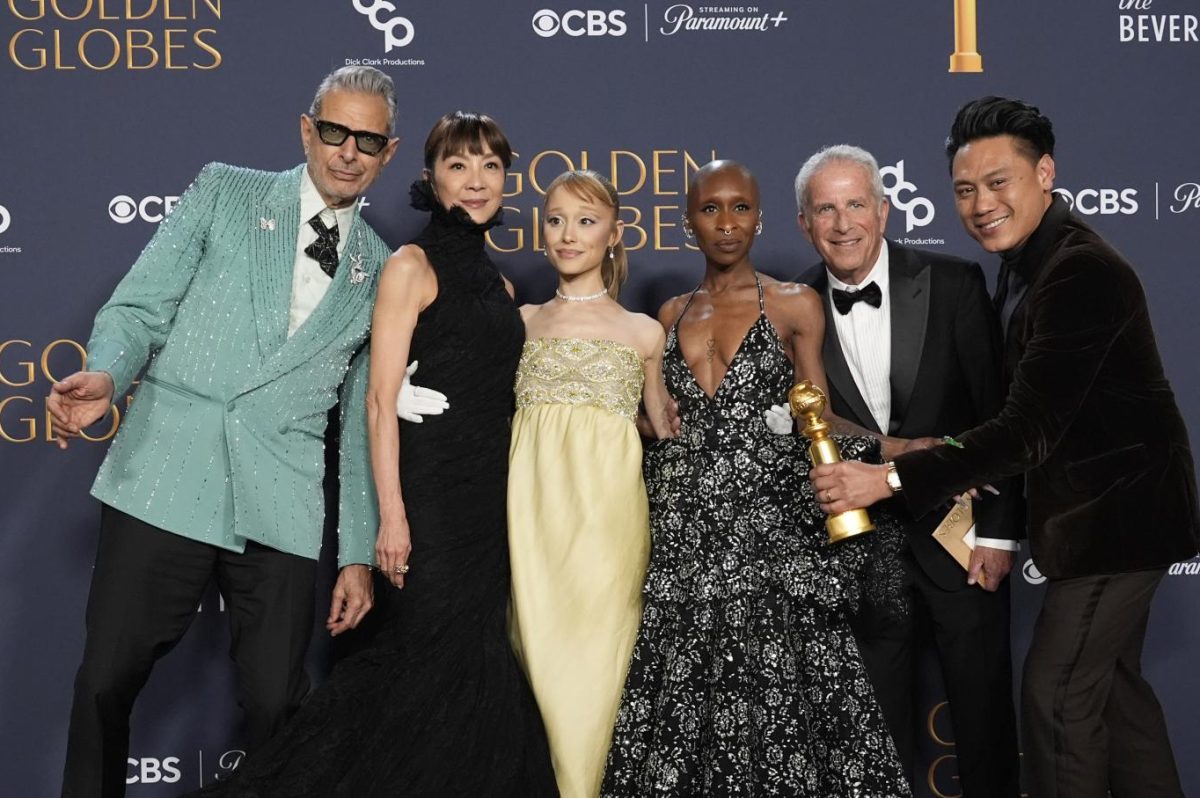  Jeff Goldblum, Michelle Yeoh, Ariana Grande, Cynthia Erivo, Marc Platt, and Jon M. Chu pose with the award for cinematic and box office achievement for "Wicked" in the press room during the 82nd Golden Globes on Sunday, Jan. 5, 2025.