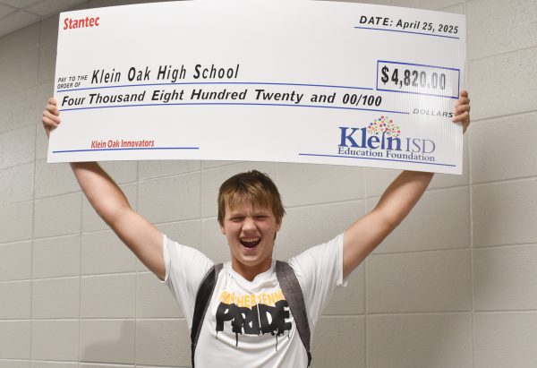 After the KISD Board of Trustees and the Klein Education Foundation surprised him in 4th period April 25, junior Caden Martin holds up the celebratory check for $4820.