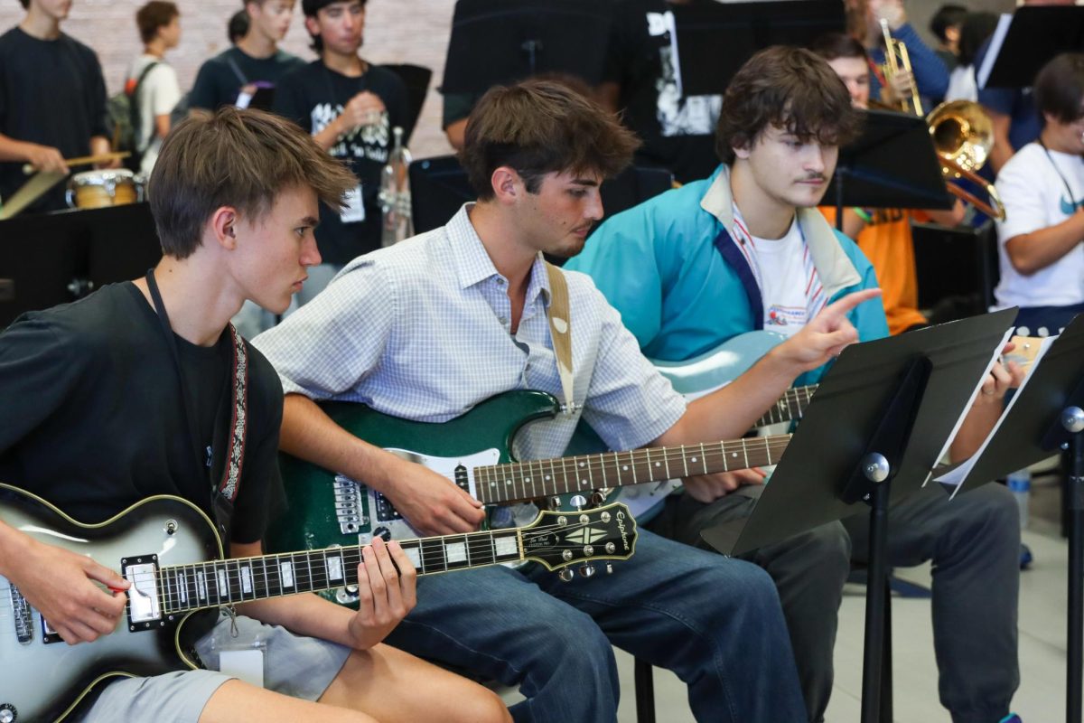 In addition to games and food choices, several fine arts groups like jazz band, the Klein Oak Break Crew and mariachi perform. Sophomore Everett Tucker, senior Owen Perrier and junior Owen Tunnell work a set for the lunch crowd.