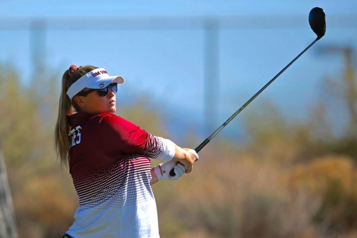 Golf Coach Amelia McKee hits a tee shot at the 2022 WAC Conference. McKee golfed at Oak and is back on campus coaching future college athletes.