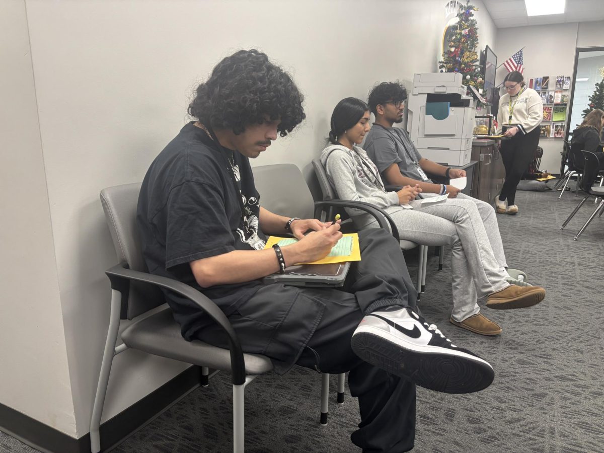 Along with other juniors, Christian Santoyo prepares for his course selection meeting with his counselor. Courses for senior year often meet college or trade school requirements so admittance into those programs is possible.