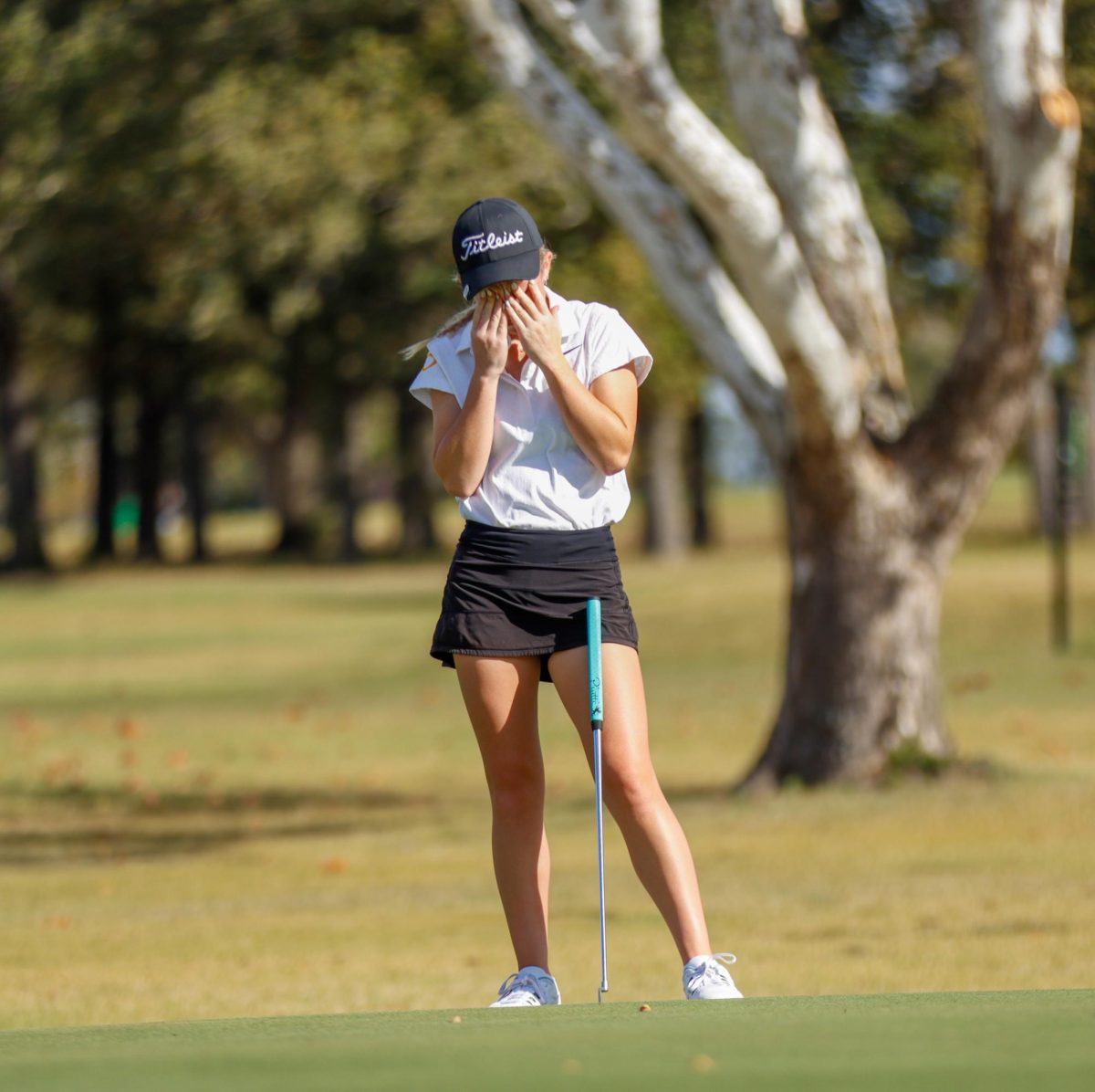 Despite the perfect alignment, Ann Smith can't believe her putt just misses the hole at the Brenham Golf Tournament.