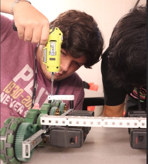 Drilling into the metal to ultimately create a competition robot, 